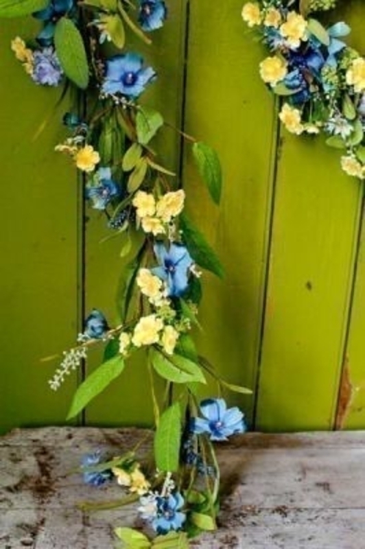 Meadow Garland of Yellow and Blue Flowers by Bloomsbury. This quality artificial floral garland will compliment any room decoration. The Blue and Yellow flowers make it particularly good for Spring and Easter. Length 1.5m.